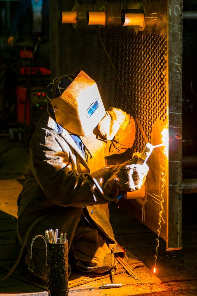 pexels-photo-2880871 A skilled welder works with a torch in an industrial environment, showcasing metalwork expertise.